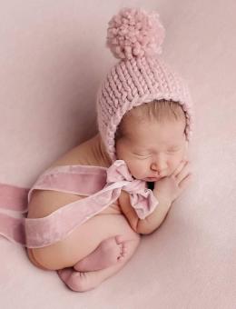 Knitted bonnet with pom pom and pants for baby girl photo shoot